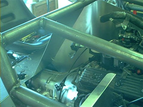1978 Ford Bronco - The interior of a vehicle shows a custom roll cage and engine parts, suggesting a project build.