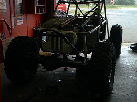 1978 Ford Bronco - Custom off-road vehicle chassis under construction, showing a roll cage and large tires.