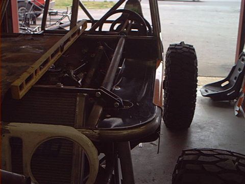 1978 Ford Bronco - Custom off-road vehicle build in progress, showing chassis, roll cage, and spare tire.
