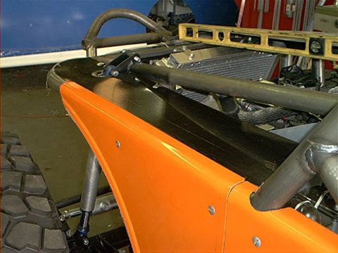 1978 Ford Bronco - Custom off-road vehicle under construction, an orange fender and extensive roll cage.