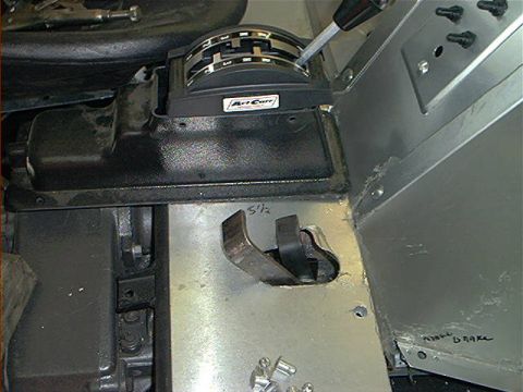 1978 Ford Bronco - The photo shows the interior of a vehicle, focusing on the shifter and brake lever mechanism. Handwritten notes are visible on the metal pa…