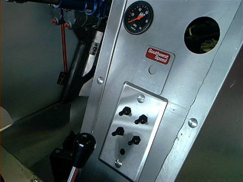 1978 Ford Bronco - Interior view of a vehicle's dashboard, showing various controls and a gauge.