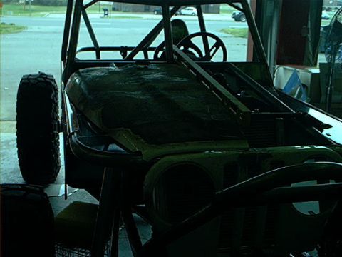 1978 Ford Bronco - This custom off-road vehicle is undergoing modifications, a prominent roll cage and large tires.