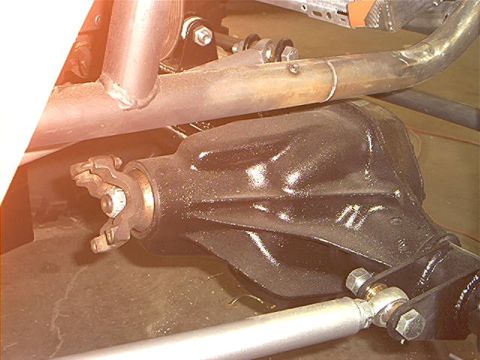1978 Ford Bronco - Close-up of a vehicle's differential housing and driveshaft U-joint, showing mechanical components.