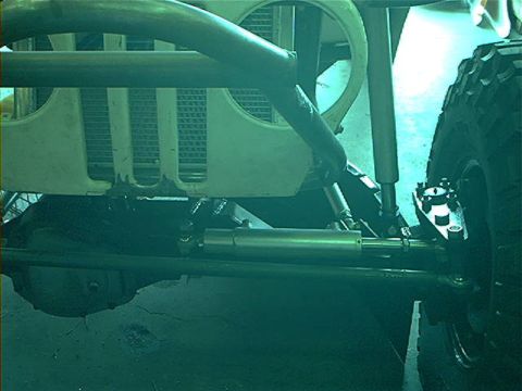 1978 Ford Bronco - Close-up of off-road vehicle front suspension and grille, possibly a custom build.