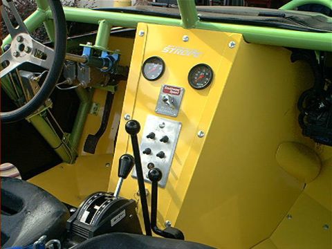 1978 Ford Bronco - Custom interior features a yellow dash panel with gauges and multiple switches, alongside a floor shifter and steering wheel.