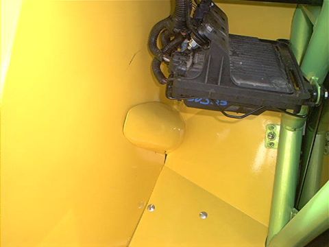 1978 Ford Bronco - Close-up of a vehicle's interior showing a radiator and wiring harness against a bright yellow background.