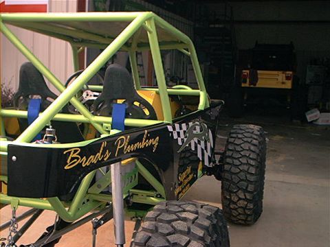 1978 Ford Bronco - Custom off-road buggy with roll cage and racing seats is parked inside a garage.