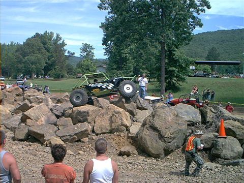 1978 Ford Bronco - Custom off-road buggy navigates a rocky obstacle course with spectators present.