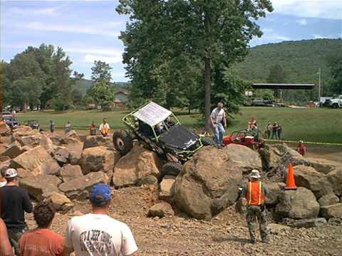 1978 Ford Bronco - A custom rock crawler vehicle maneuvers through a challenging obstacle course of large rocks.