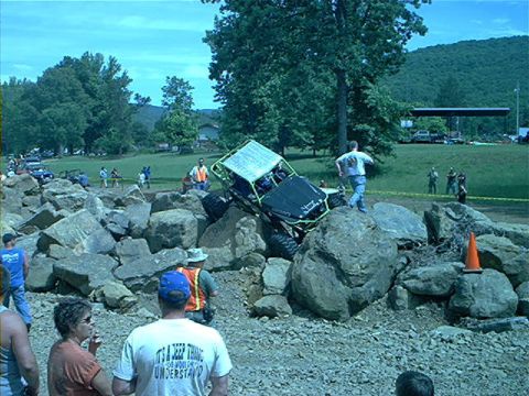 1978 Ford Bronco - A custom off-road buggy navigates a challenging rock obstacle course with spectators present.
