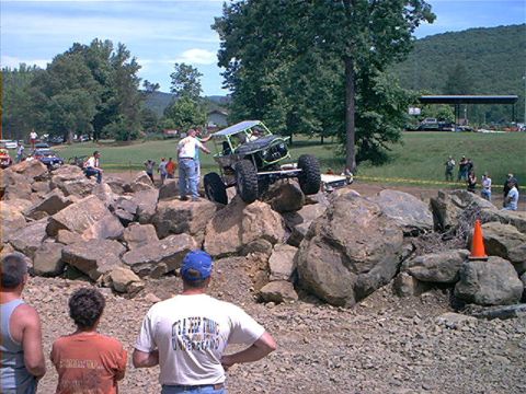 1978 Ford Bronco - A custom-built rockcrawler navigates a challenging obstacle course, with onlookers observing the event.