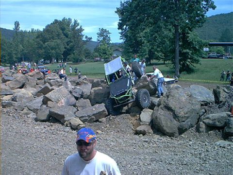 1978 Ford Bronco - A custom off-road buggy navigates a challenging rocky terrain with spectators nearby.
