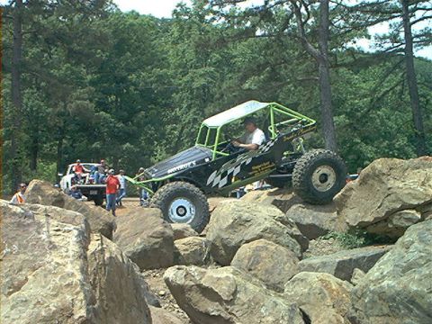 1978 Ford Bronco - This custom buggy navigates a rocky trail with spectators and another vehicle nearby.