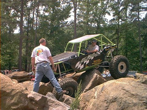 1978 Ford Bronco - A custom-built buggy navigates a challenging rocky terrain with assistance from a spotter.