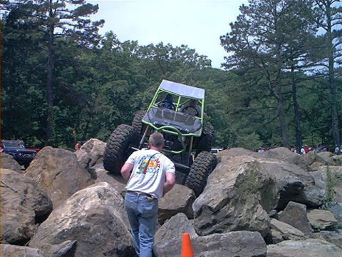 1978 Ford Bronco - A custom-built rock crawler navigates a challenging obstacle course with spectators nearby.