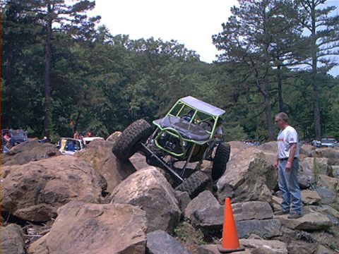 1978 Ford Bronco - A custom rock crawler navigates a challenging boulder course with spectators present.