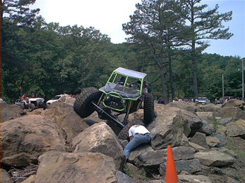 1978 Ford Bronco - A custom-built buggy attempts to conquer a challenging rock crawling course with spectators in the background.