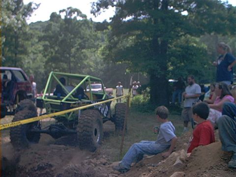 1978 Ford Bronco - A custom rock crawler navigates an obstacle course, with spectators watching from the side.