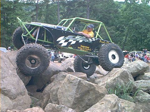 1978 Ford Bronco - Custom off-road buggy tackles a challenging rock crawling course with spectators in the background.