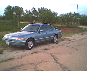 1994 Ford Crown Victoria - This 1994 Ford Crown Victoria is seen from a 3/4 front angle on a dirt road.