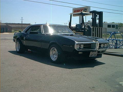 1978 Ford Bronco - Black 1967 Pontiac Firebird coupe with chrome trim and aftermarket wheels parked on asphalt.