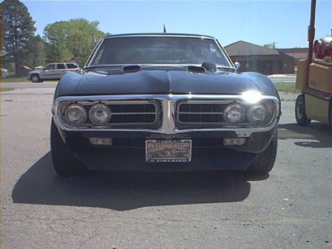 1978 Ford Bronco - Front view of a 1967 Pontiac Firebird, identified by its 'Intimidator' license plate.