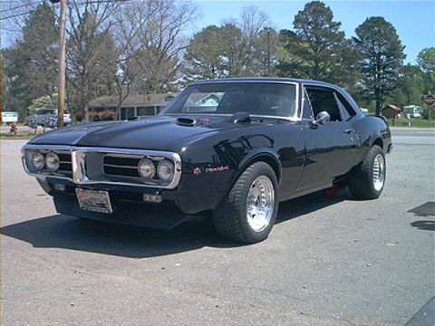 1978 Ford Bronco - This black coupe features a distinctive grille and hood scoops, indicating a classic American muscle car.