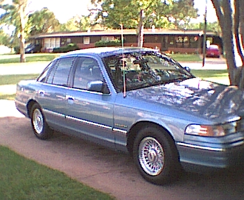 1994 Ford Crown Victoria - A light blue 1994 Ford Crown Victoria is parked on a concrete driveway.