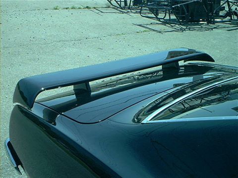 1978 Ford Bronco - Aftermarket rear spoiler installed on a car's trunk lid.
