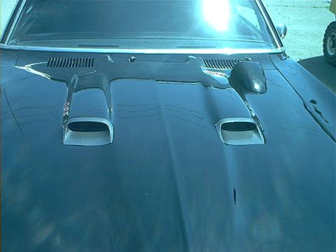 1978 Ford Bronco - Hood scoops and side mirror on a car's hood, no year visible.