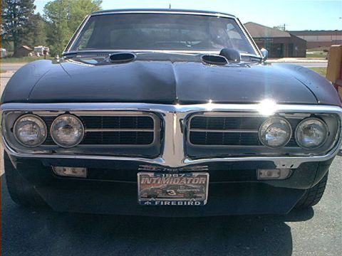 1978 Ford Bronco - Front view of a black 1967 Pontiac Firebird with hood scoops and a "Intimidator 3 Firebird" license plate.