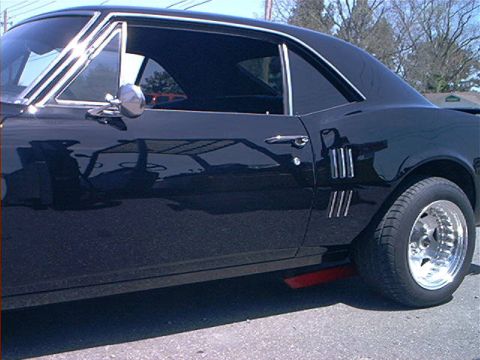 1978 Ford Bronco - This black coupe features distinctive side vents and chrome trim, characteristic of a 1967 Pontiac Firebird.