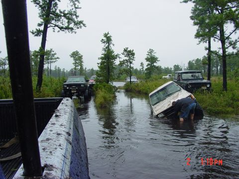 1995 Dodge 1500 - Multiple off-road vehicles are stuck in a flooded area during an off-road excursion.