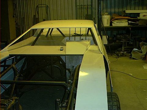 1978 Ford Bronco - A partially completed race car, viewed from the front-right, sits in a workshop environment with visible roll cage structure.