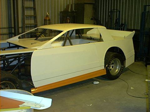 1978 Ford Bronco - A custom-built race car body is shown in a workshop, awaiting further modifications and assembly.