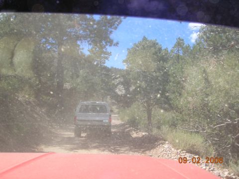 1985 Ford Bronco - Driving a 1985 Ford Bronco on a dirt road surrounded by trees. Another vehicle is ahead.