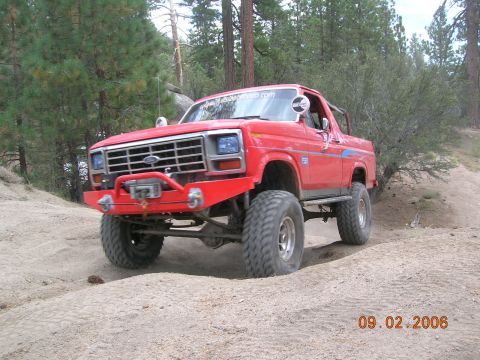 1985 Ford Bronco - This red Ford Bronco is equipped for off-road use, large tires and a modified bumper.