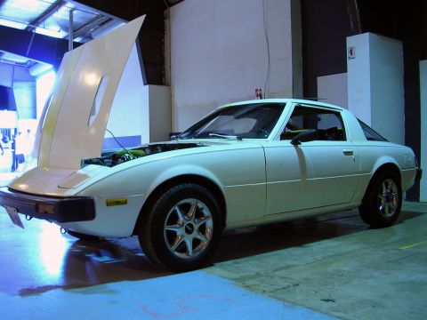 1996 Ford Probe - A white coupe with its hood open, revealing the engine compartment.