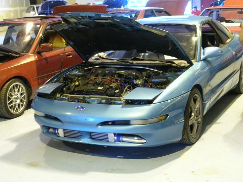 1996 Ford Probe - A blue 1996 Ford Probe is parked indoors with its hood up, revealing the engine bay.