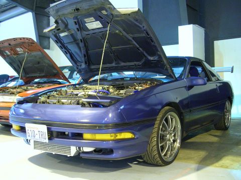 1996 Ford Probe - Blue 1996 Ford Probe with hood open, parked next to an orange car.