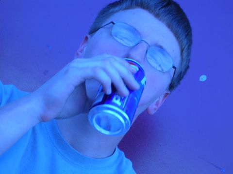 1996 Ford Probe - A person drinks from a can, with reflections visible in their glasses.