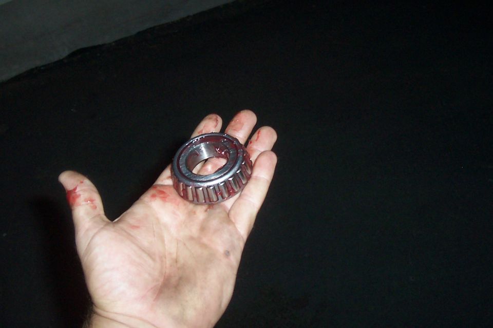 Wheel bearing held in a bloody hand