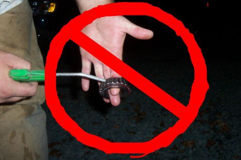 1994 Ford F-150 - A hand holds a bearing with a tool, marked with a red prohibition symbol.