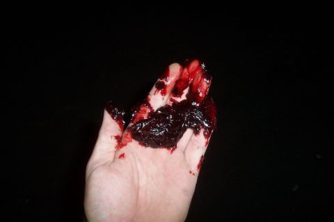 1994 Ford F-150 - A hand is covered in a dark, viscous fluid mixed with blood.