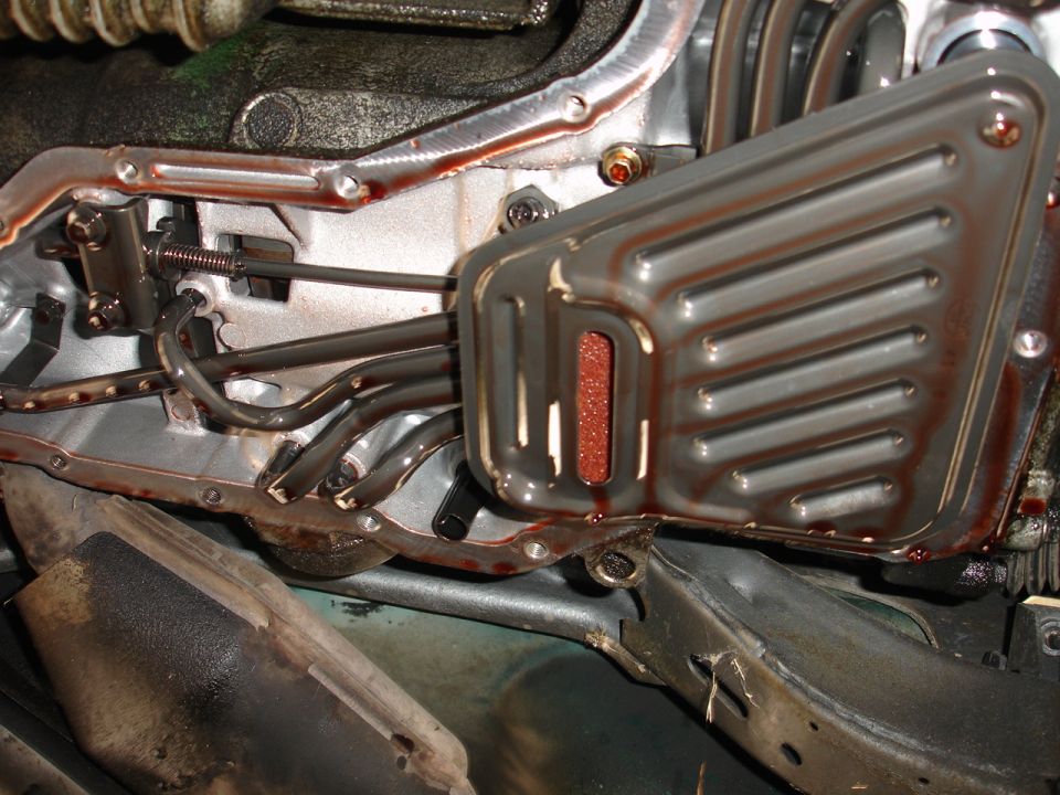 Transmission pan and filter with reddish fluid visible