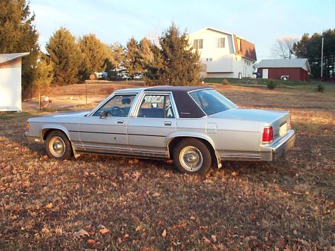 1991 Ford Crown Victoria - This 1988 Ford LTD Crown Victoria is seen from the side in a rural setting with houses in the background.