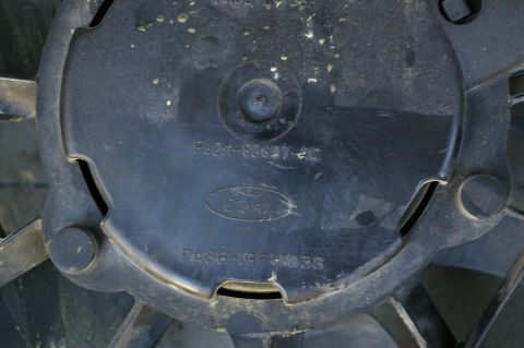 1986 Ford Bronco - Close-up of a black electric fan with Ford branding and part numbers.