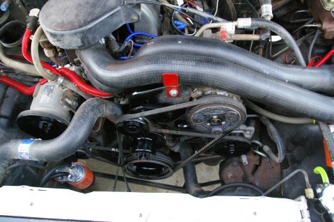 1986 Ford Bronco - Close-up view of an engine compartment, showing various mechanical components.