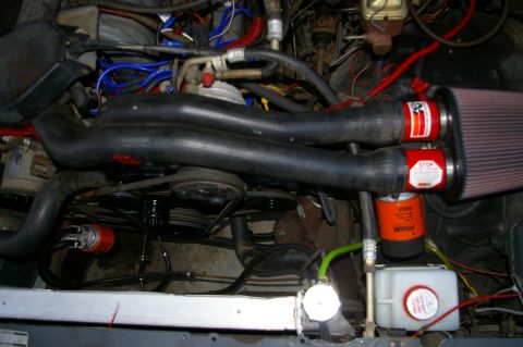 1986 Ford Bronco - Close-up of an engine compartment aftermarket K&N air filters and a FRAM oil filter.